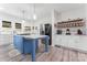 Modern kitchen with a large island, stainless steel appliances, and white countertops at 509 N Oak St, Lincolnton, NC 28092