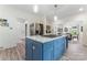 A view of the kitchen shows a blue island with white countertops and stainless steel appliances at 509 N Oak St, Lincolnton, NC 28092