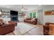 The cozy living room is decorated with leather furniture and a fireplace at 509 N Oak St, Lincolnton, NC 28092