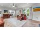 This living room has hardwood floors, leather furniture, and lots of natural light at 509 N Oak St, Lincolnton, NC 28092