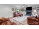 Relaxing living room with leather furniture, a ceiling fan, and a cozy fireplace at 509 N Oak St, Lincolnton, NC 28092