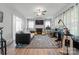 Bright music room with a fireplace, large windows, and a variety of instruments at 509 N Oak St, Lincolnton, NC 28092