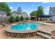 Beautiful kidney shaped pool with cascading waterfall feature, stone patio and gazebo at 509 N Oak St, Lincolnton, NC 28092