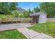 Backyard shed with covered patio and a gravel area fenced in with wooden benches at 509 N Oak St, Lincolnton, NC 28092