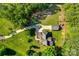An aerial view of a home with a detached garage, fire pit, playground, and large grassy yard at 546 Little Cove Ln, Lake Wylie, SC 29710