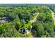 Aerial view of a private home nestled among the trees and situated in a wooded neighborhood at 546 Little Cove Ln, Lake Wylie, SC 29710