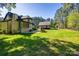 Green backyard featuring a patio with outdoor furniture, mature trees, and play structure at 546 Little Cove Ln, Lake Wylie, SC 29710