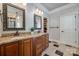 Double vanity with granite counters, wood cabinets and decorative mirrors at 546 Little Cove Ln, Lake Wylie, SC 29710