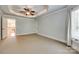 Large bedroom featuring tray ceilings, a ceiling fan and access to other rooms at 546 Little Cove Ln, Lake Wylie, SC 29710