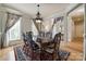 Formal dining area with hardwood floors, large windows, decorative rug and dining table at 546 Little Cove Ln, Lake Wylie, SC 29710