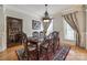 Dining room featuring hardwood floors, ornate chandelier, wainscoting, and formal dining table at 546 Little Cove Ln, Lake Wylie, SC 29710
