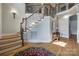 Spacious foyer with wood flooring, staircase with wrought iron railing, and decorative rug at 546 Little Cove Ln, Lake Wylie, SC 29710
