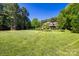 Spacious front yard with lush lawn and mature trees framing this lovely home's facade at 546 Little Cove Ln, Lake Wylie, SC 29710