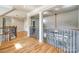 Hallway with hardwood floors, iron and wood railing overlooking stairwell to downstairs at 546 Little Cove Ln, Lake Wylie, SC 29710