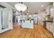 Open concept kitchen features white cabinets, granite counters, stainless appliances, and hardwood floors at 546 Little Cove Ln, Lake Wylie, SC 29710