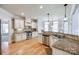 Bright kitchen with granite countertops, stainless steel appliances, custom cabinetry and hardwood floors at 546 Little Cove Ln, Lake Wylie, SC 29710