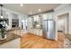 Bright kitchen features white cabinets, granite counters, stainless appliances, and hardwood flooring at 546 Little Cove Ln, Lake Wylie, SC 29710