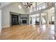 Spacious living room featuring hardwood floors, stone fireplace, vaulted ceiling, and second story balcony at 546 Little Cove Ln, Lake Wylie, SC 29710