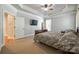 Spacious bedroom with tray ceiling, neutral carpet, and view to a bright window at 546 Little Cove Ln, Lake Wylie, SC 29710