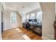 Bright home office area with hardwood floors, built-in desk, storage and natural light from three windows at 546 Little Cove Ln, Lake Wylie, SC 29710