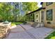 Outdoor patio with a stone grill, and steps that lead to a sunroom with many windows at 546 Little Cove Ln, Lake Wylie, SC 29710