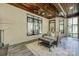 Cozy sunroom with wood ceiling, sitting area, and lots of natural light from the windows at 546 Little Cove Ln, Lake Wylie, SC 29710