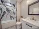 Stylish bathroom boasts a marble-look tiled shower-tub and elegant white sink with marble countertop at 574 Crescent Rd, Rockwell, NC 28138