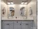 Bathroom with stylish glass vessel sinks and granite countertops beneath decorative octagon framed mirrors at 574 Crescent Rd, Rockwell, NC 28138