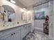 Elegant bathroom featuring glass vessel sinks, granite countertop, and stone-framed doorway at 574 Crescent Rd, Rockwell, NC 28138