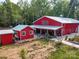Red barn-style home with well-maintained landscaping and separate accessory building at 574 Crescent Rd, Rockwell, NC 28138