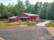 Aerial view of red barn style home and surrounding grounds at 574 Crescent Rd, Rockwell, NC 28138