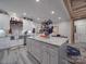 Modern kitchen with gray island, granite counters, white cabinets and stainless steel sink at 574 Crescent Rd, Rockwell, NC 28138