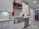 Kitchen sink with stainless steel appliances, open shelves, and white cabinets at 574 Crescent Rd, Rockwell, NC 28138
