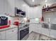 Close up of kitchen with stainless steel appliances, white cabinets, and gray subway tile at 574 Crescent Rd, Rockwell, NC 28138