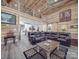 Bright living room features wood walls, ceiling fan, loft area, and open kitchen layout at 574 Crescent Rd, Rockwell, NC 28138