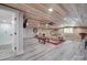 Basement living room featuring a beamed ceiling with a ceiling fan, hardwood floors, and a sofa at 574 Crescent Rd, Rockwell, NC 28138