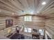 Aerial view of living room with beamed ceiling, hardwood floors, and a large stained glass window at 574 Crescent Rd, Rockwell, NC 28138