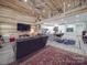 Open-concept living area with high ceilings and modern finishes overlooking the kitchen at 574 Crescent Rd, Rockwell, NC 28138