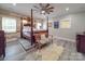Spacious main bedroom features a four-poster bed, wood-style floors, and natural light from multiple windows at 574 Crescent Rd, Rockwell, NC 28138