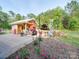 Outdoor area showcasing a patio area, a bird feeder, landscaping, and an outdoor building with a white roof at 574 Crescent Rd, Rockwell, NC 28138