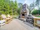Outdoor fireplace featuring stone and an outdoor grill area with lounge seating at 574 Crescent Rd, Rockwell, NC 28138