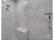 Modern shower features white marble style tiles, corner seat, and a sleek shower head at 574 Crescent Rd, Rockwell, NC 28138