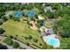 Aerial view of the community amenities including a playground, tennis courts, parking, and pool at 6206 Glencairn Ct, Charlotte, NC 28269