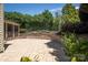 Stunning back patio area with lush landscaping and stone retaining wall, perfect for outdoor entertaining at 6206 Glencairn Ct, Charlotte, NC 28269