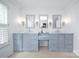 Bright bathroom featuring a double vanity, three decorative mirrors, and plantation shutters for natural light at 6206 Glencairn Ct, Charlotte, NC 28269