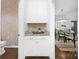 Butler pantry with granite counters, white cabinets, and decorative wallpaper at 6206 Glencairn Ct, Charlotte, NC 28269