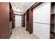 Spacious walk-in closet with custom built-in shelving and drawers, illuminated by a decorative ceiling light at 6206 Glencairn Ct, Charlotte, NC 28269