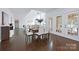 Dining room with vaulted ceilings, hardwood floors, and patio access at 6206 Glencairn Ct, Charlotte, NC 28269