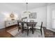 Elegant dining room featuring modern chandelier, decorative wall art, and hardwood floors at 6206 Glencairn Ct, Charlotte, NC 28269