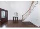 Bright foyer with hardwood floors, staircase, and decorative entryway table at 6206 Glencairn Ct, Charlotte, NC 28269